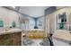 Bright bathroom with a tiled shower, sunken tub, and dual vanity sinks at 6503 Big Horn Trl, Littleton, CO 80125