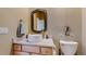 Elegant powder room features a vessel sink, decorative mirror, and contemporary fixtures at 6503 Big Horn Trl, Littleton, CO 80125