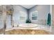 Bathroom featuring a soaking tub, tiled shower, and modern fixtures at 6503 Big Horn Trl, Littleton, CO 80125