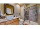 Bathroom featuring stylish vanity, a vessel sink, and a walk-in shower at 6503 Big Horn Trl, Littleton, CO 80125