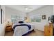 Bright bedroom with leafy patterned bedding, and natural light from the exterior view at 6503 Big Horn Trl, Littleton, CO 80125