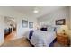 Bright bedroom with leafy patterned bedding, and open access to the kitchen/hallway at 6503 Big Horn Trl, Littleton, CO 80125