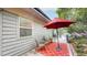 Outdoor deck with an umbrella and outdoor furniture including views of mature trees and beautiful natural light at 6503 Big Horn Trl, Littleton, CO 80125