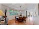 Traditional dining room features a dark wood table, chairs, and large windows with blinds for natural light at 6503 Big Horn Trl, Littleton, CO 80125