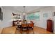 Dining room with hardwood floors, a wooden table with chairs, a decorative light fixture and natural light at 6503 Big Horn Trl, Littleton, CO 80125