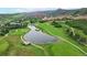 Aerial view of golf course, showcasing its scenic pond, well-maintained fairways, and lush landscaping at 6503 Big Horn Trl, Littleton, CO 80125
