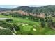Scenic aerial view of a meticulously manicured golf course with sand traps and lush greens at 6503 Big Horn Trl, Littleton, CO 80125