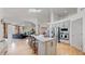 Bright and open kitchen featuring stainless steel appliances, a large island, and a seamless flow to the living area at 6503 Big Horn Trl, Littleton, CO 80125