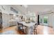 Updated kitchen with a large island, pendant lighting, stainless appliances, and hardwood floors at 6503 Big Horn Trl, Littleton, CO 80125