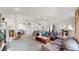 Bright, open living room showcases stairs, a ceiling fan, hardwood floors, and inviting seating area at 6503 Big Horn Trl, Littleton, CO 80125