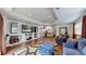 Bright living room featuring a large flat screen TV and comfortable seating area with wood look floors and recessed lighting at 6503 Big Horn Trl, Littleton, CO 80125