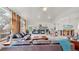 Spacious living room features a vaulted ceiling, large windows, a stone fireplace, plush furniture, and a ceiling fan at 6503 Big Horn Trl, Littleton, CO 80125