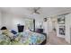 Inviting bedroom with ensuite access, deck, and a ceiling fan for added comfort at 6503 Big Horn Trl, Littleton, CO 80125