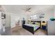 Spacious bedroom featuring a ceiling fan, large windows, and access to an ensuite at 6503 Big Horn Trl, Littleton, CO 80125