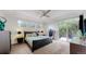 Bright main bedroom with deck access, ceiling fan, and large windows at 6503 Big Horn Trl, Littleton, CO 80125