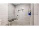 Modern glass enclosed shower with bench and contemporary fixtures and tile at 6503 Big Horn Trl, Littleton, CO 80125