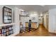 Spacious hallway with wet bar featuring granite counters, and tiled flooring at 6503 Big Horn Trl, Littleton, CO 80125