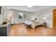 Comfortable bedroom with hardwood floors, bright windows, modern decor, and a mini-split air conditioner at 27100 Molly Dr, Conifer, CO 80433