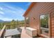 Deck area with seating and mountain views, wood flooring, and windows looking into the home at 27100 Molly Dr, Conifer, CO 80433