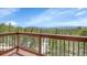 Deck with stunning mountain views and a wooden railing, overlooking the natural forest landscape at 27100 Molly Dr, Conifer, CO 80433