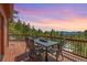 Outdoor deck features a dining table set with views of mountain and sunset at 27100 Molly Dr, Conifer, CO 80433