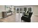 Comfortable living room with an electric fireplace, hardwood floors, and large windows with treed views at 27100 Molly Dr, Conifer, CO 80433