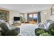 Cozy living room with an adjacent deck and mountain views at 27100 Molly Dr, Conifer, CO 80433