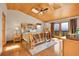 Spacious main bedroom with vaulted wood ceiling, skylight, balcony, and rustic wooden bed frame at 27100 Molly Dr, Conifer, CO 80433