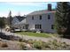 Backyard features a stone patio perfect for entertaining, a sprawling lawn, and mature trees at 2879 Gold Creek Dr, Elizabeth, CO 80107