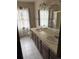 Bathroom featuring double sinks, tile countertops, and a separate shower at 2879 Gold Creek Dr, Elizabeth, CO 80107