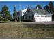 Classic home exterior featuring a three car garage, mature trees and well-maintained landscaping at 2879 Gold Creek Dr, Elizabeth, CO 80107