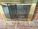 This home's fireplace features a vintage gold screen and decorative brick surround at 2879 Gold Creek Dr, Elizabeth, CO 80107