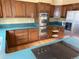This kitchen features ample wood cabinetry, stainless steel appliances, and a breakfast bar cooktop at 2879 Gold Creek Dr, Elizabeth, CO 80107