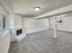 Basement features a fireplace, neutral carpet, and bright windows at 6189 Pontiac St, Commerce City, CO 80022
