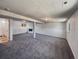Spacious finished basement area featuring neutral carpet, white walls and support beams at 6189 Pontiac St, Commerce City, CO 80022