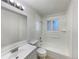 Clean, all-white bathroom with tub, shower, and bright lighting, offering a fresh and functional space at 6189 Pontiac St, Commerce City, CO 80022
