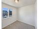 Bright bedroom features neutral carpet, a large window and fresh white paint at 6189 Pontiac St, Commerce City, CO 80022