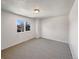 Bright, minimalist bedroom with natural light and neutral carpet, perfect for personalization at 6189 Pontiac St, Commerce City, CO 80022