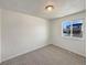 Neutral bedroom with a large window allowing ample natural light and plush carpeting at 6189 Pontiac St, Commerce City, CO 80022