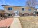 Inviting two-story home featuring a manicured lawn and a welcoming entrance under a clear blue sky at 6189 Pontiac St, Commerce City, CO 80022