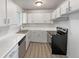 Modern white kitchen featuring sleek countertops and stainless steel appliances for a clean, contemporary look at 6189 Pontiac St, Commerce City, CO 80022