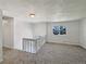 Cozy upstairs loft area with carpet and a bright window overlooking the neighborhood at 6189 Pontiac St, Commerce City, CO 80022