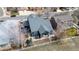 Aerial view of a home with a fenced backyard, landscaping, and a shed in a residential neighborhood at 319 Mountain View Ave, Fort Lupton, CO 80621