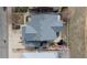 An aerial view of the home shows a gray roof, an expansive driveway, a small pond, and a fenced backyard at 319 Mountain View Ave, Fort Lupton, CO 80621