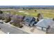 Aerial view showcasing a landscaped house in a golf course neighborhood at 319 Mountain View Ave, Fort Lupton, CO 80621