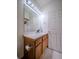 Bathroom featuring a vanity with sink, mirror, and a tiled floor at 319 Mountain View Ave, Fort Lupton, CO 80621