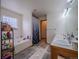 Well-lit bathroom with dual sinks, bathtub and neutral walls at 319 Mountain View Ave, Fort Lupton, CO 80621