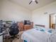 A bright bedroom featuring a ceiling fan, and view to a bathroom through an open doorway at 319 Mountain View Ave, Fort Lupton, CO 80621