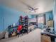 Spacious bedroom featuring bunk beds, work area, and neutral carpet at 319 Mountain View Ave, Fort Lupton, CO 80621