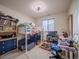 Bedroom featuring a window, bookcase, ceiling fan, and a bunk bed at 319 Mountain View Ave, Fort Lupton, CO 80621